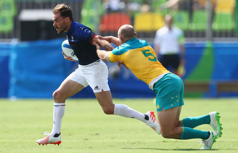 France’s Terry Bouhraoua invites James Stannard of Australia along for a sweet game of Ride My Arm Down the Field at the Pool B match between Australia and France. Image via Getty.